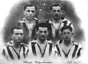 Photo of five men in soccer uniforms